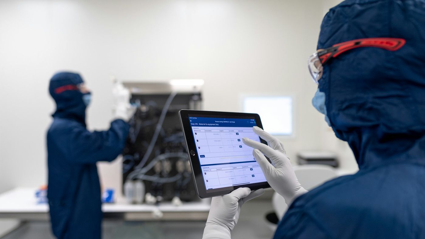 A small team reviewing something together on a computer screen